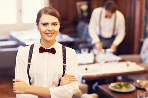 Waiters standing in restaurant photo