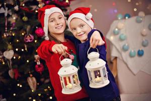 Happy children posing with Christmas lanterns photo