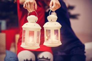 Happy children posing with Christmas lanterns photo