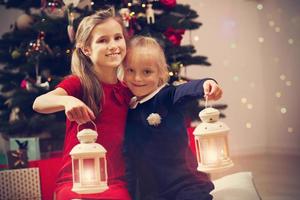Happy children posing with Christmas lanterns photo