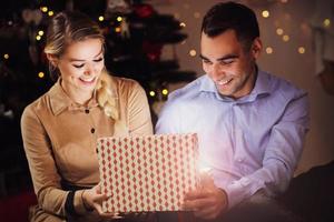 Happy Couple Opening Christmas Present photo