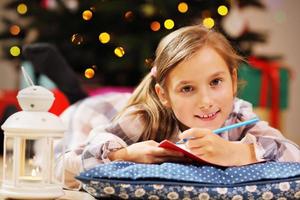 Happy Girl Writing Christmas Letter to Santa Claus photo