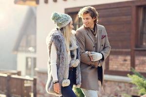 Happy couple walking outdoors in winter photo