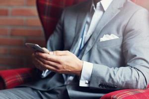 Young businessman texting on a smartphone photo