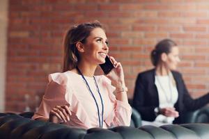 Young businesswomen texting on a smartphone photo