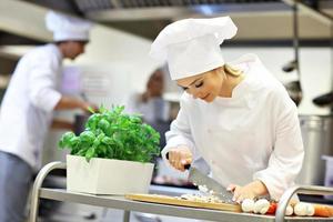 Busy chefs at work in the restaurant kitchen photo