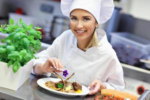 Busy chef at work in the restaurant kitchen photo