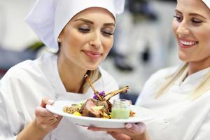 Busy chefs at work in the restaurant kitchen photo