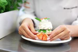 Busy chef at work in the restaurant kitchen photo