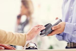 People paying in hotel reception photo