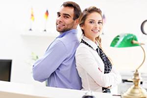 Happy team of hotel receptionists photo