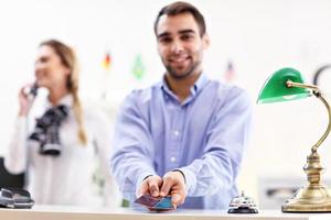 Happy receptionist working in hotel photo