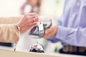 Hotel receptionist giving key card photo