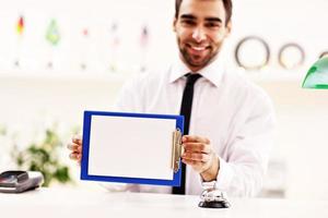 Happy receptionist working in hotel photo