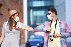 Happy tourists sightseeing in masks during summer holidays photo