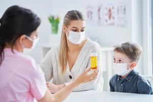 Little boy in mask having medical examination by pediatrician covid-19 concept photo