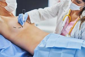 Plastic surgeon consulting a female patient photo