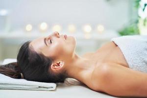 Adult woman during relaxing massage in spa photo