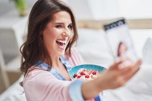 Young woman in underwear eating cereals photo