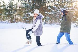 Couple walking in high snow during winter photo