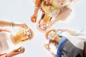 Group of friends blowing soap bubbles photo