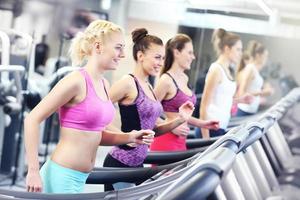 Group of women jogging on treadmill photo