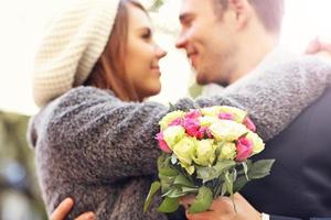 Young couple kissing in the park photo