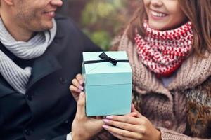 Young couple with present in the city photo