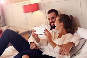 Happy couple resting in hotel room photo