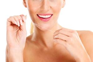 Woman using dental floss photo