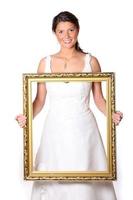 Beautiful bride with gold frame photo