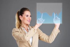 Businesswoman and touchscreen photo