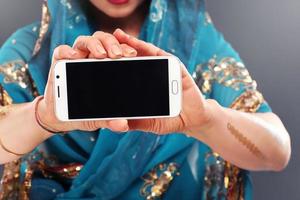 Arabic woman holding smartphone photo