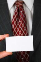 Business man holding business card photo