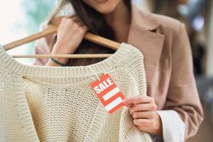 Young girl on shopping during sale holding tag photo