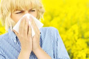 Woman with allergy over flowers photo