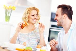 Happy couple eating breakfast photo