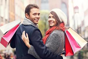 Happy couple shopping in the city photo