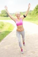 Successful woman jogging in the park photo