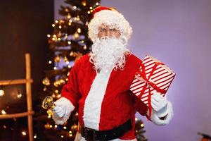 Santa Claus and Christmas tree with present photo