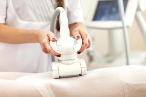 Woman having abdominal treatment in beauty salon photo