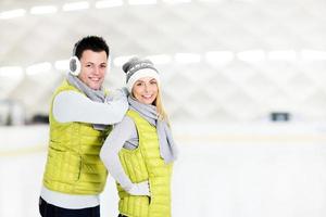 Cheerful couple in the skating rink photo