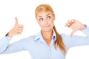 Confused woman with thumbs up and down photo