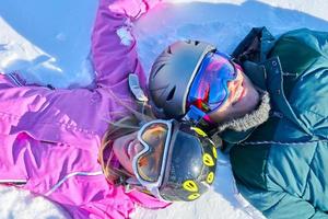 Young couple having fun on the snow photo