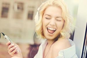 Young woman listening to music at home photo