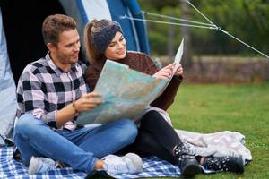 Young nice couple having fun on camping photo