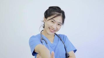 Asian female doctor thumbs up showing excellence video