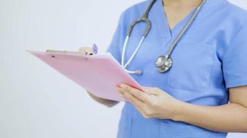 Close-up video of an Asian female nurse prescribing medication.