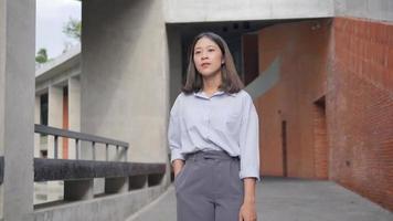 Young businesswoman in front of the company video