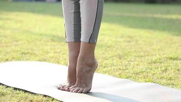 Close-up video of a woman's leg performing tadasana, or mountain pose, while exercising.